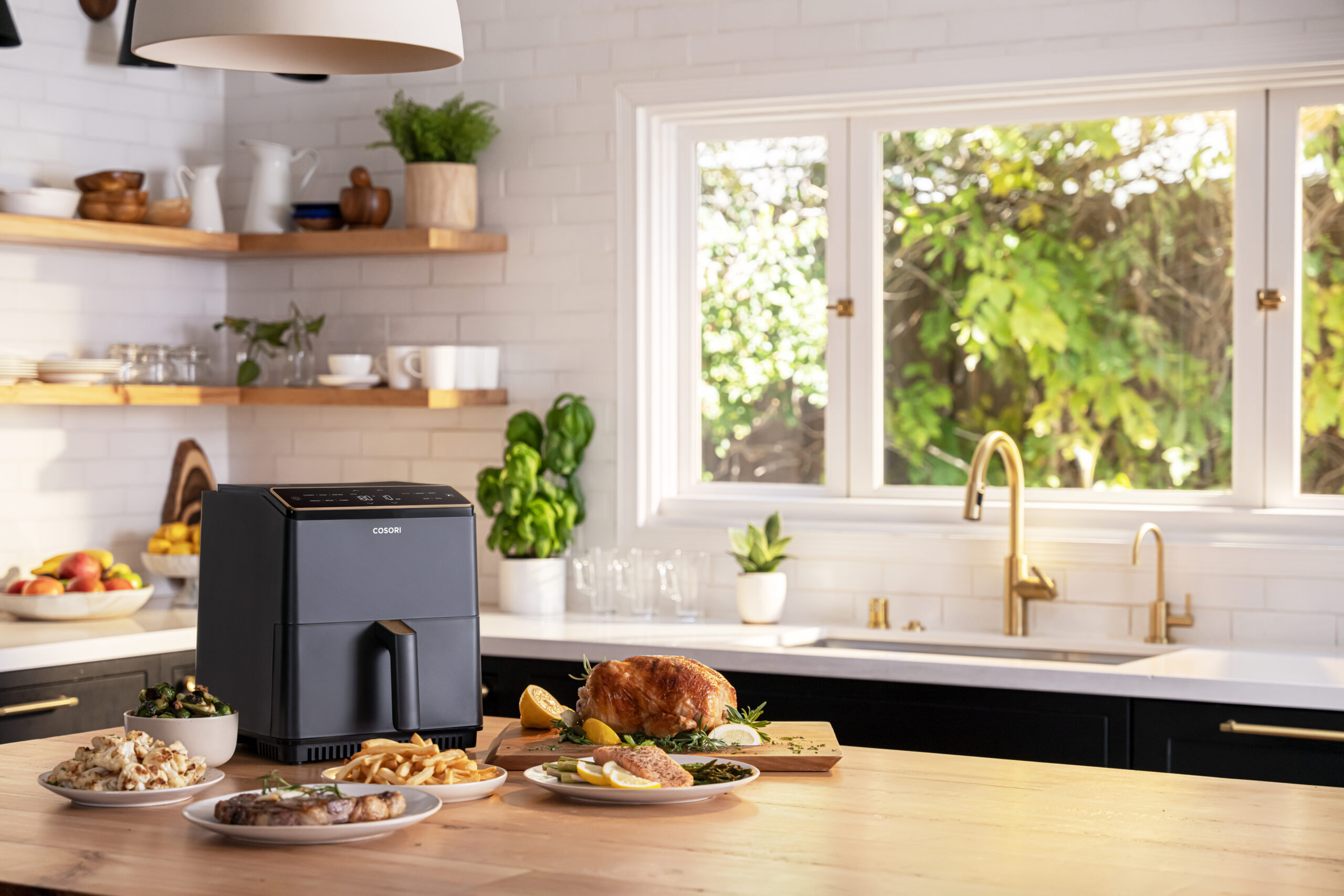 COSORI Dual Blaze air fryer in a family kitchen with roast chicken and fries